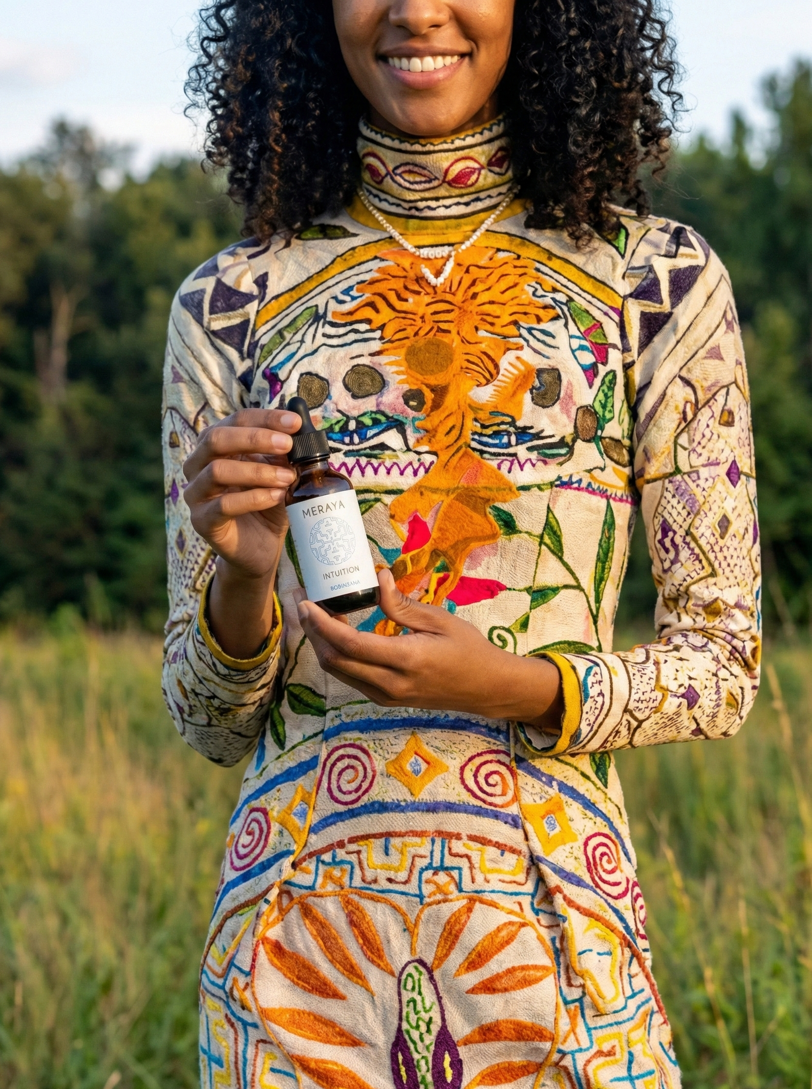 Woman in a colorful patterned outfit holding a bottle of meraya bobinsana in a natural setting