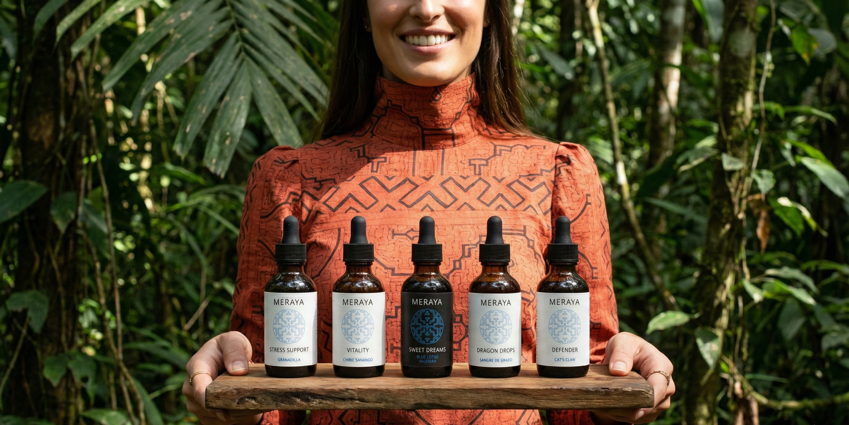 Woman holding a tray with five bottles of a product in a forest setting